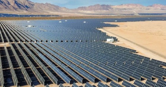 Rows of ground-mount solar panels at a large desert solar farm